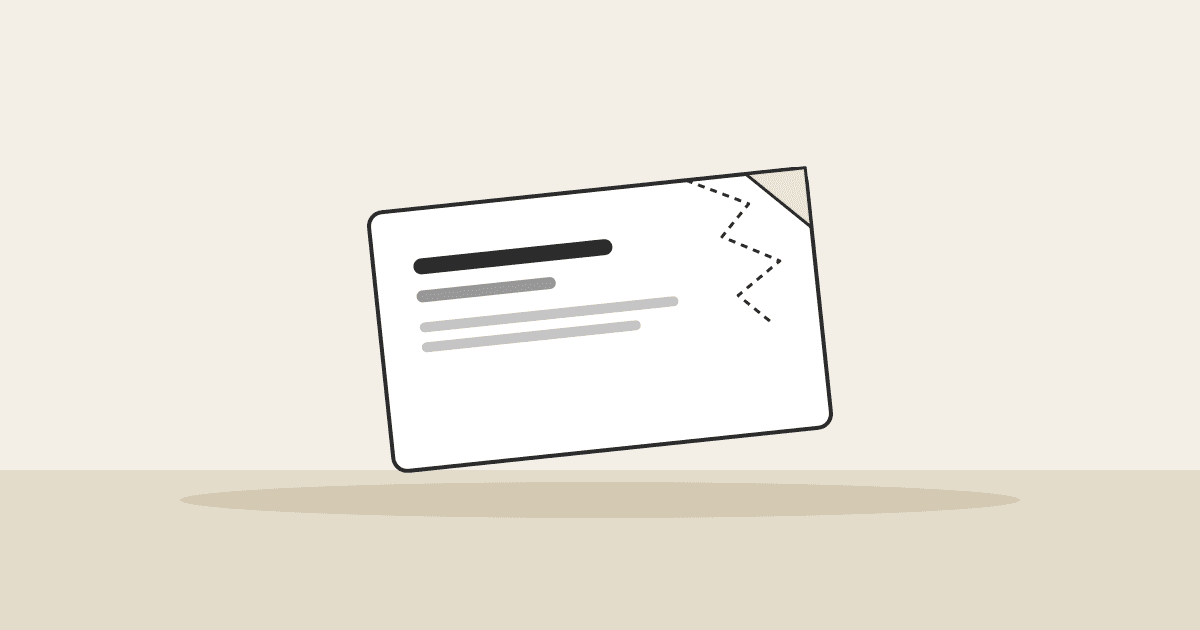 Header illustration: a business card lying on a table with one corner crumpled